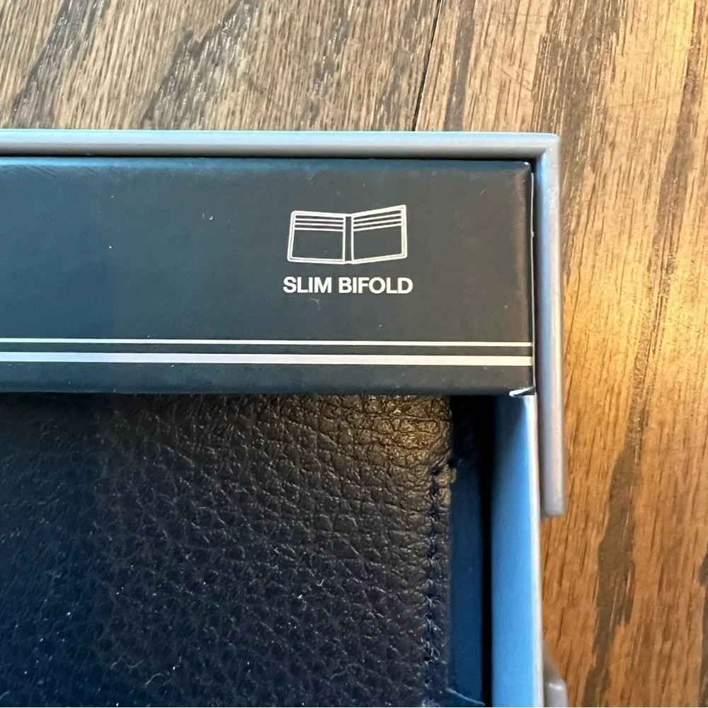 NWT Perry Ellis navy slim bifold leather wallet in box.